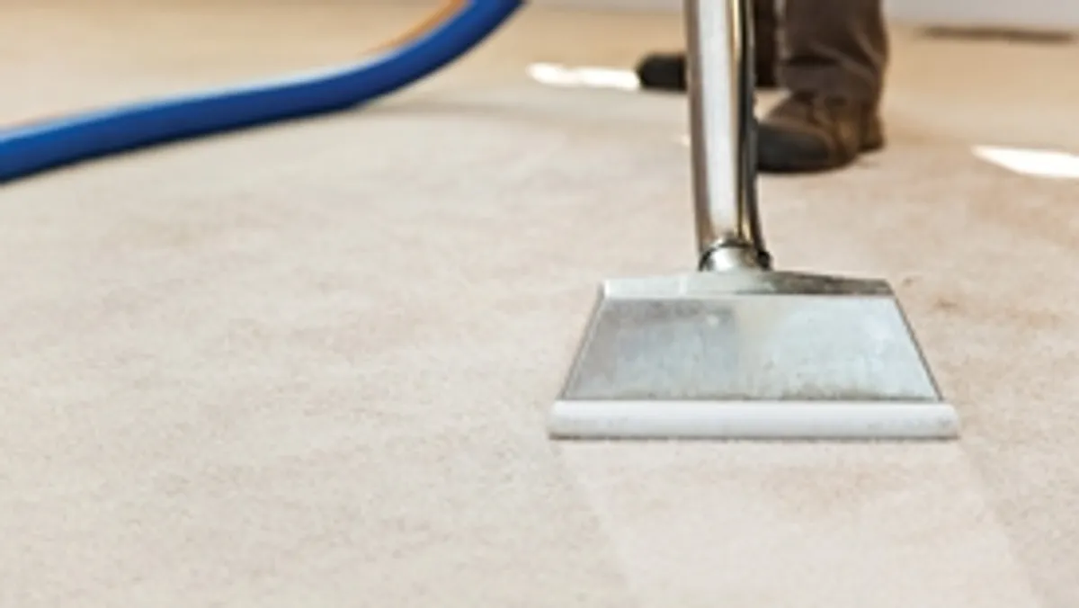 Carpet cleaning wand head gliding over a light carpet during hot-water extraction, Baltimore, MD.